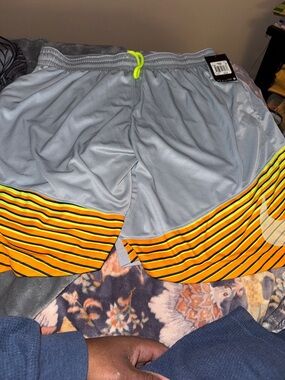 Nike Men's Light Gray Athletic Shorts with Yellow Stripe Hem and Neon Drawcord